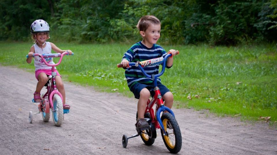 Two children riding their bikes on the GAP trailhead Two children riding their bikes on the GAP trailhead