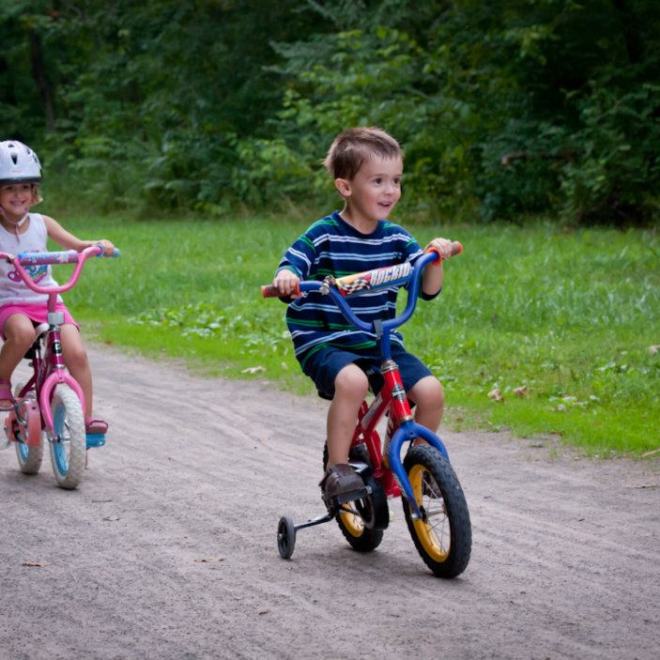 Two children riding their bikes on the GAP trailhead