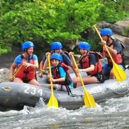 Family on raft in the white water rapids