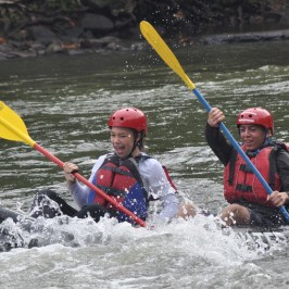 Two people rafting on white water rapids