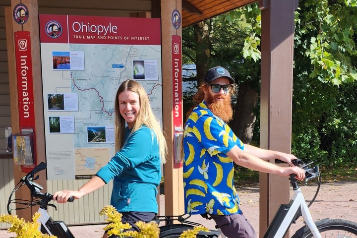 a person sitting on a bicycle in front of a building