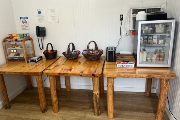 a kitchen with a microwave on top of a wooden table