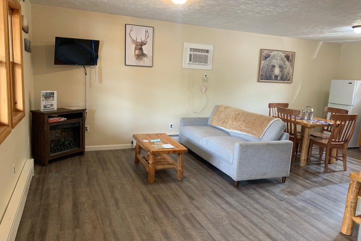 a living room filled with furniture and a wood floor