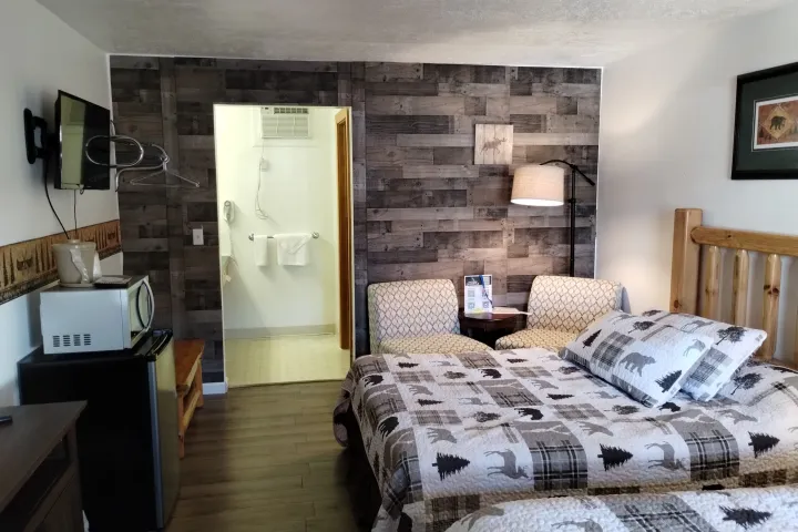 a bedroom with a bed and a chair in a room