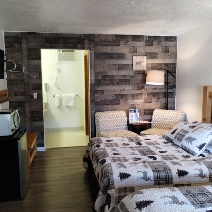 a bedroom with a bed and desk in a room