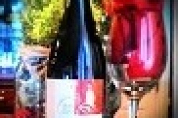 a bottle and a glass of wine